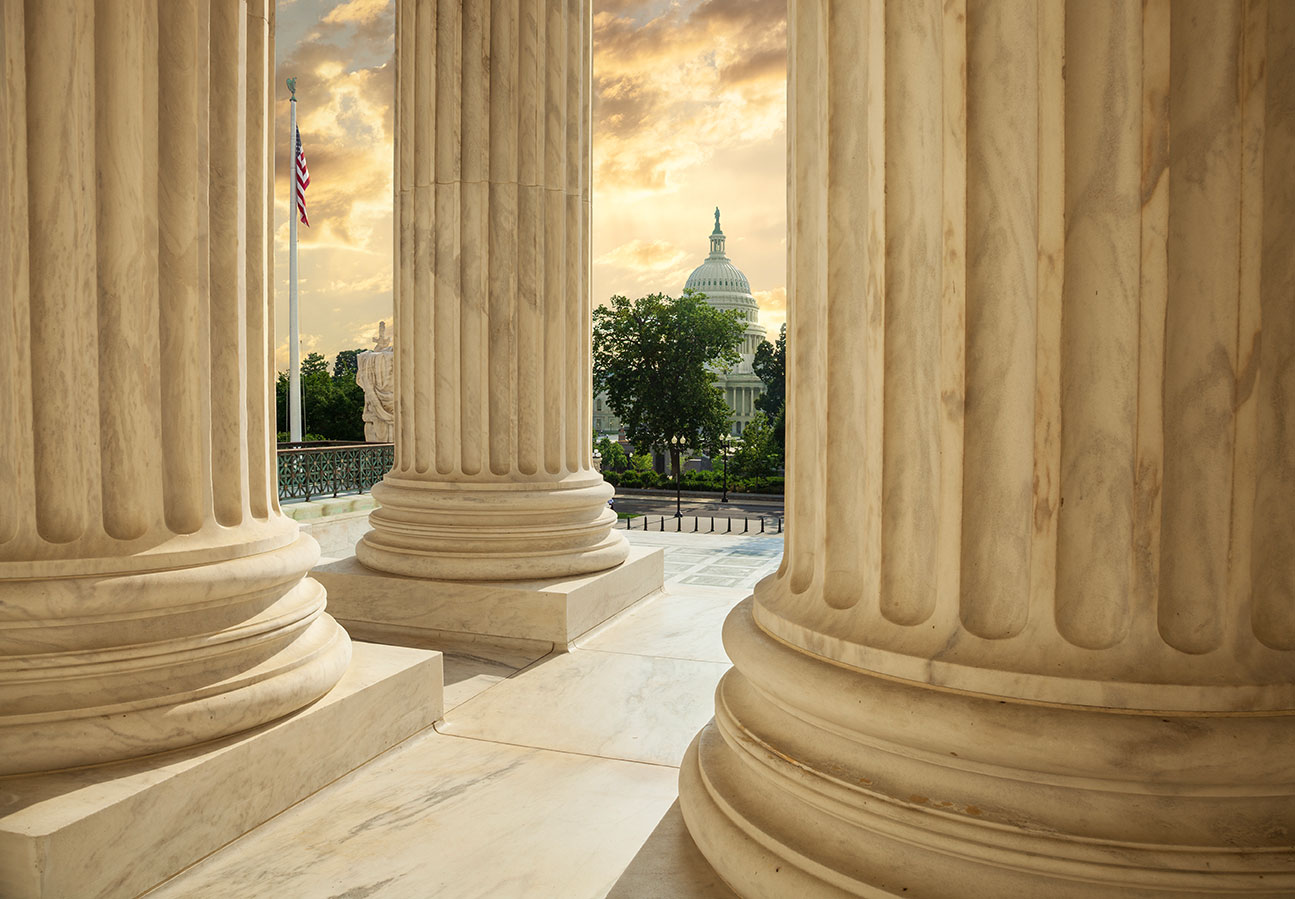 Columns of the Supreme Court with the United States Capitol beyond